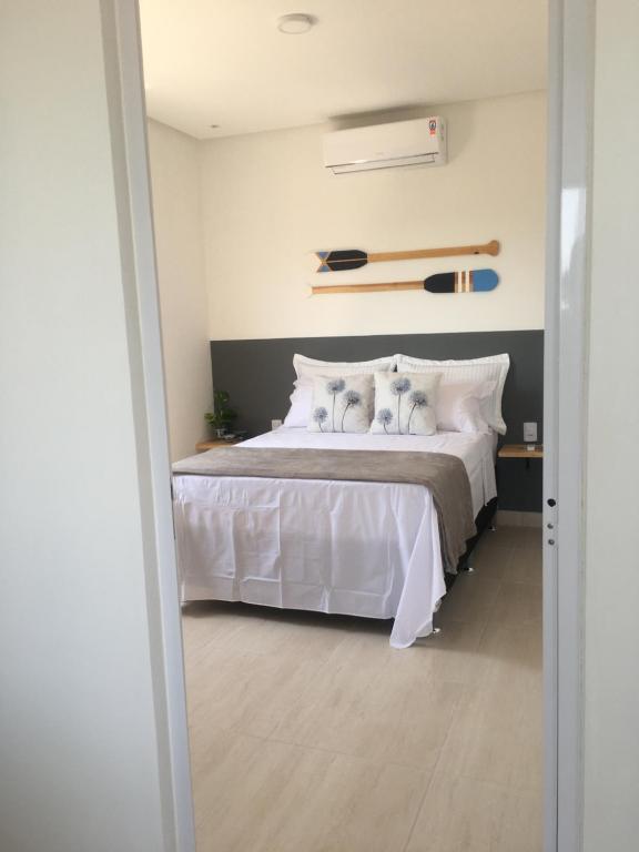 a bedroom with a bed with two dogs on it at Sua casinha de férias em Icapui e Tibau in Icapuí