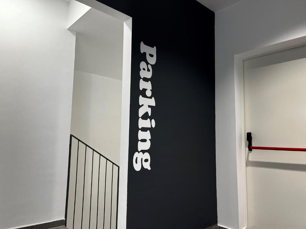 a black and white wall with a sign on it at Hs Madrid Centro Atocha in Madrid