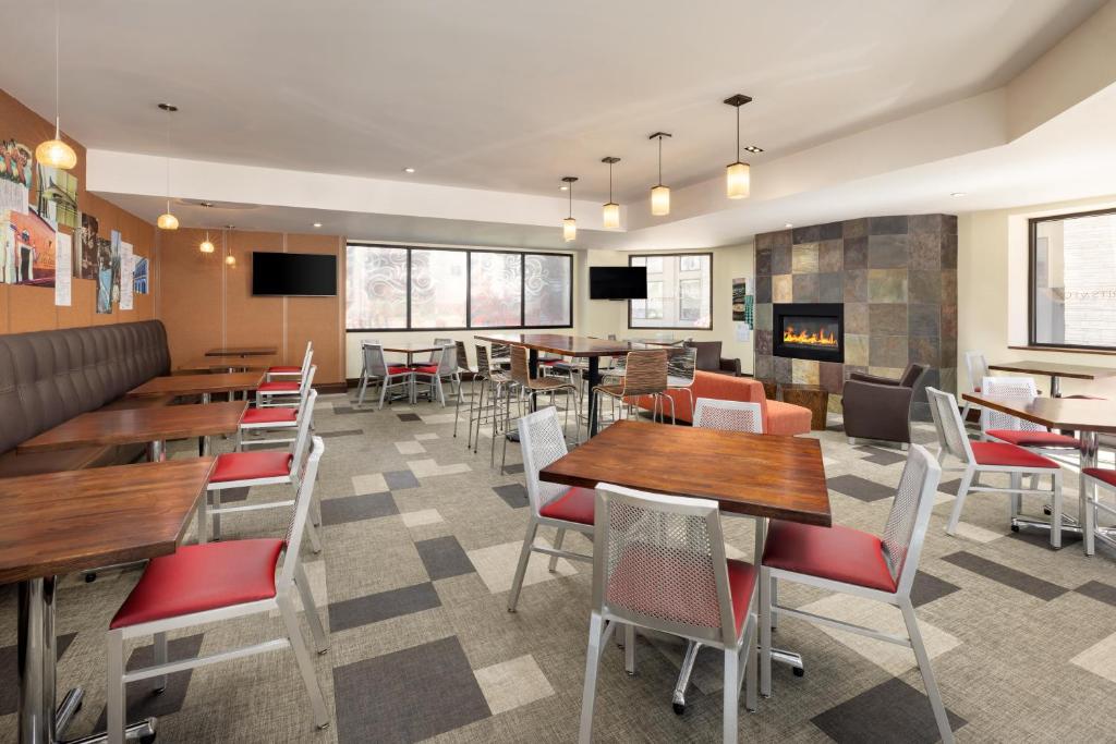 a restaurant with tables and chairs and a fireplace at Elevation Hotel & Spa in Crested Butte