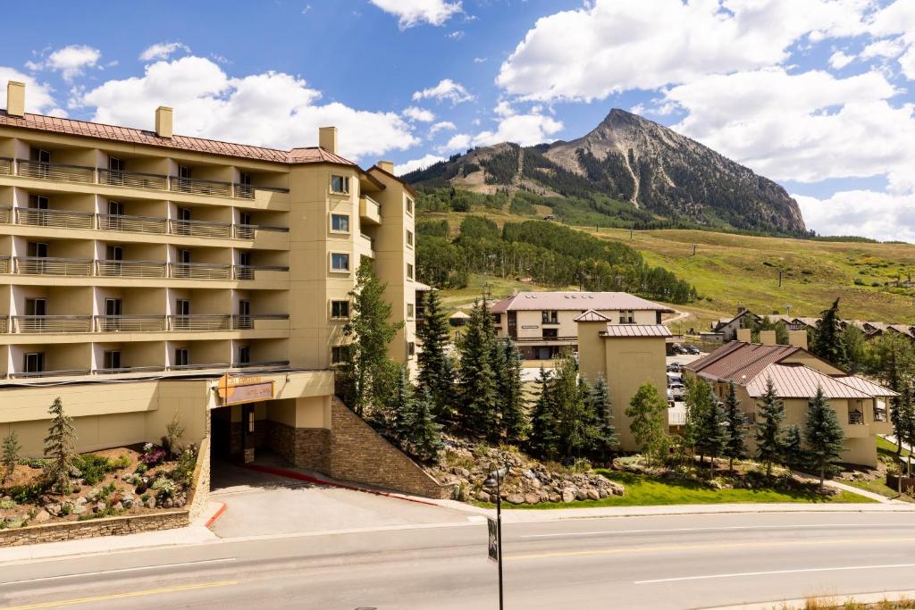 a view of a hotel with a mountain in the background at Elevation Hotel & Spa in Crested Butte
