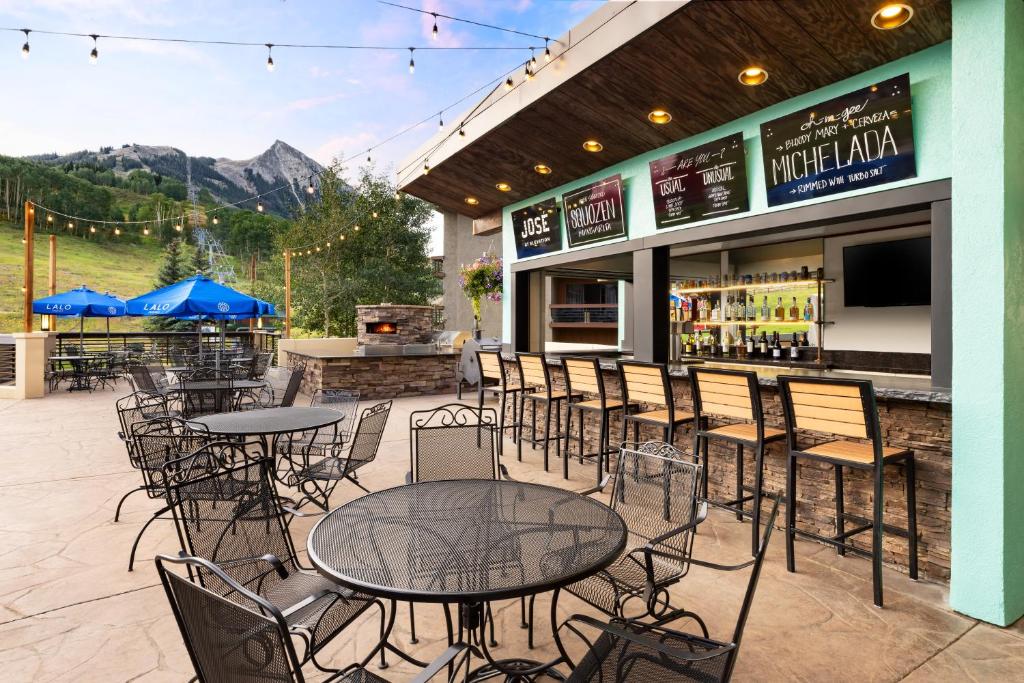 a patio with tables and chairs in front of a restaurant at Elevation Hotel & Spa in Crested Butte