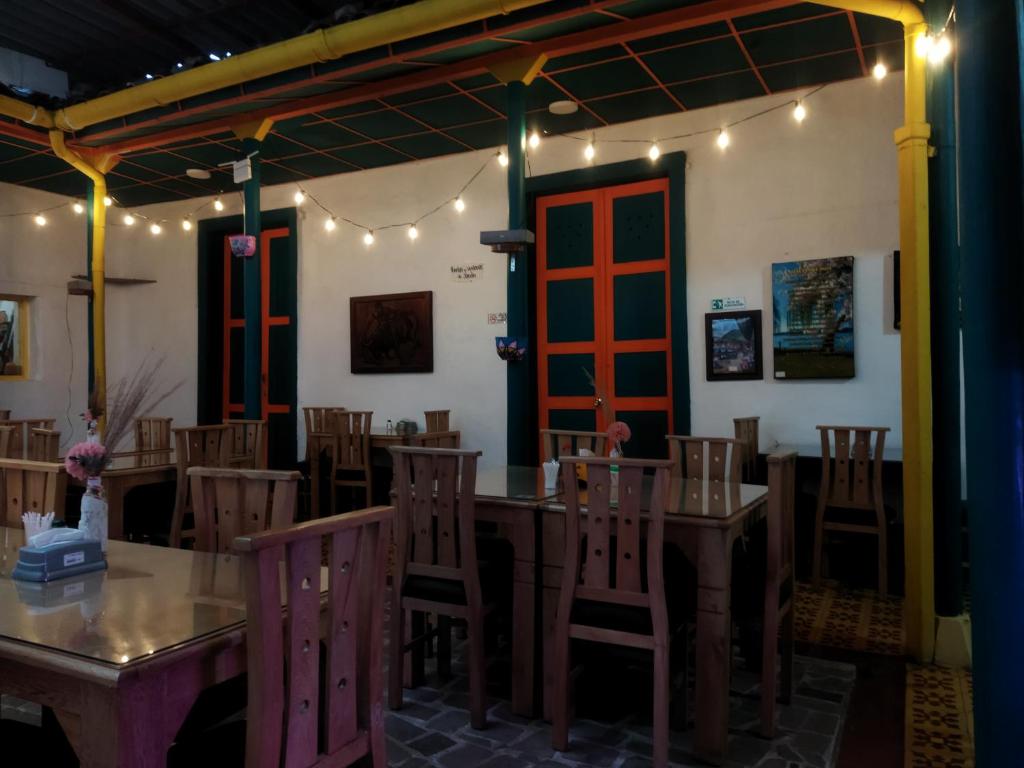 a dining room with tables and chairs and lights at Jard&iacute;n es Tuyo in Jardin