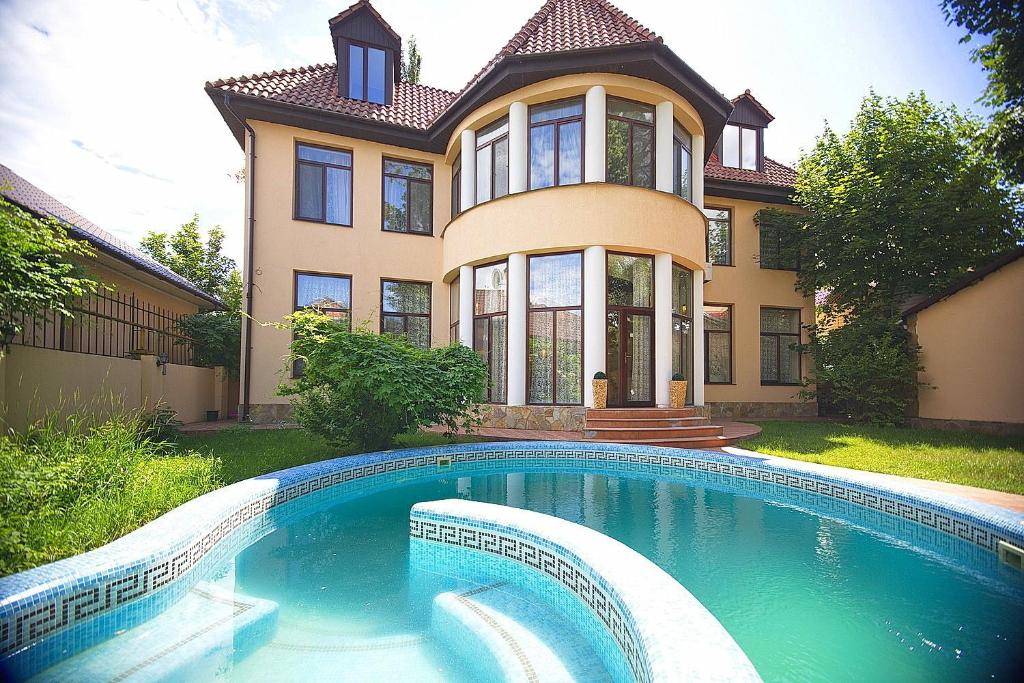 a house with a swimming pool in front of a house at Luxury Villa in Odesa