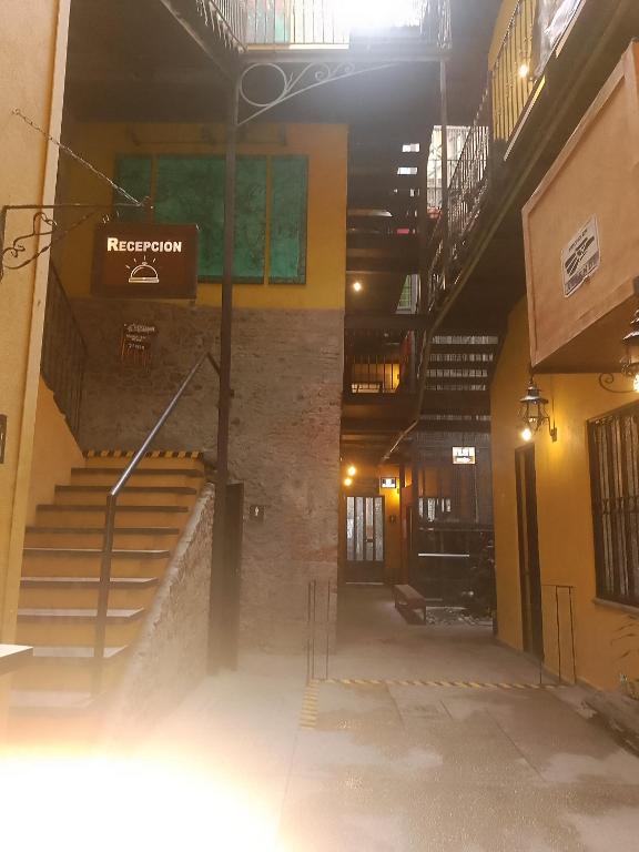 an empty hallway of a building with stairs and a sign at Hotel Sonno Plaza Allende in Mexico City