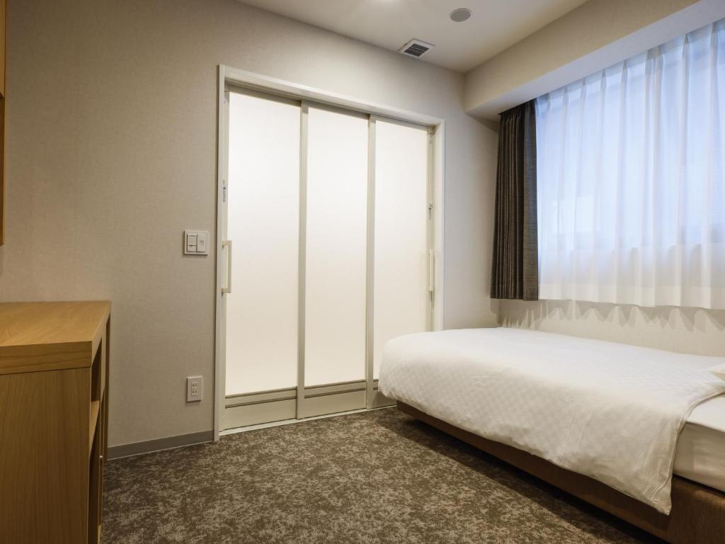 Postel nebo postele na pokoji v ubytování Plum Hotel