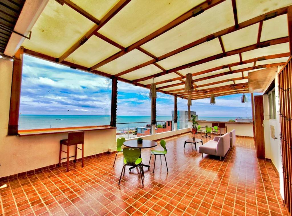 a living room with a view of the ocean at HOTEL MAESJHU in Atacames