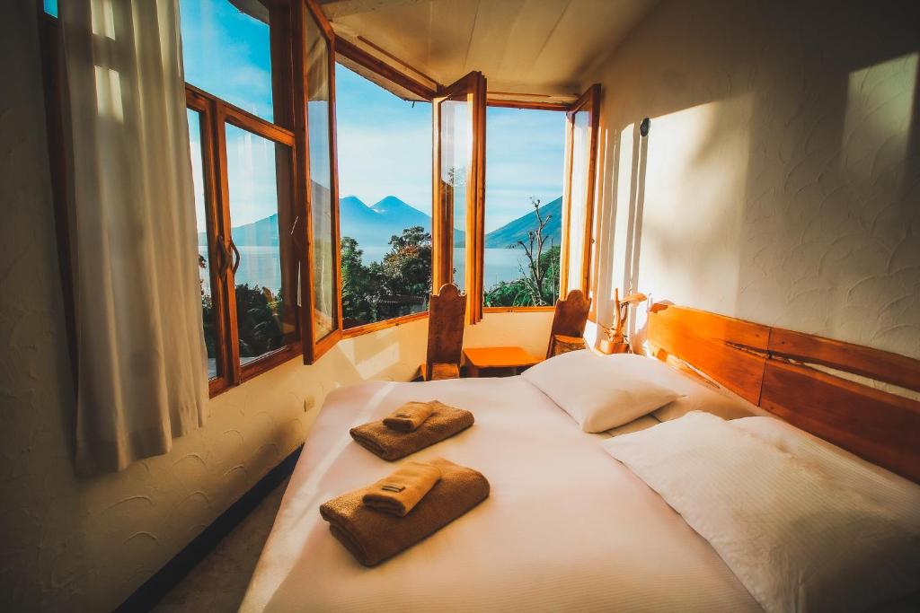 a bedroom with a bed with two towels on it at Lush Atitlán in San Marcos La Laguna