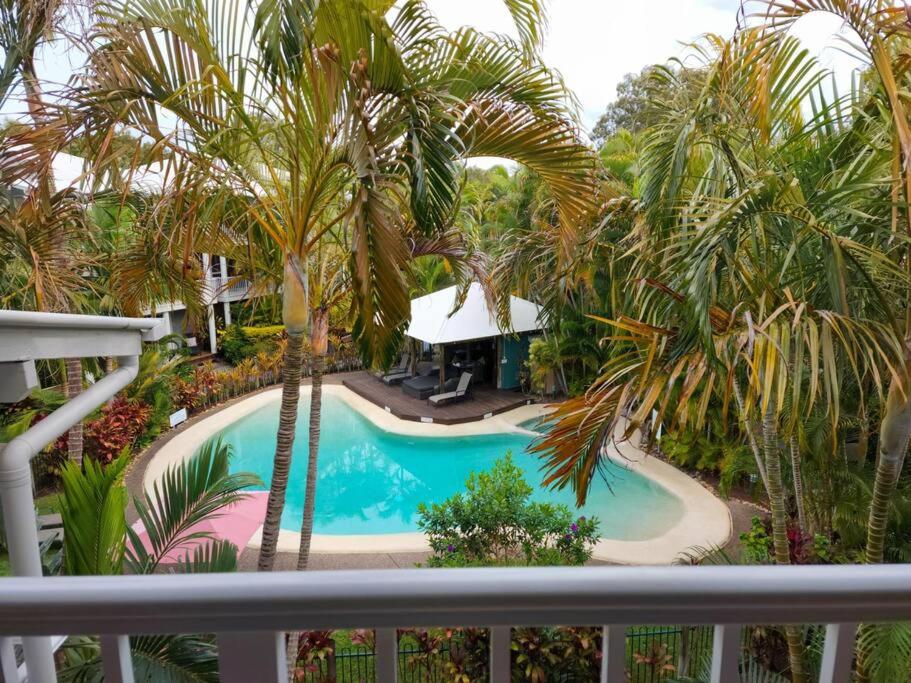 a view of a swimming pool from a balcony at Luxury Top Floor Sunset Villa in Noosaville
