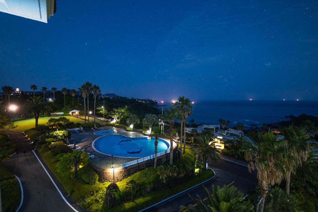 a view of a swimming pool at night at Seaore Resort in Seogwipo