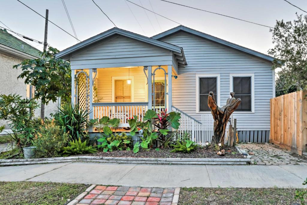 a tiny house with a porch and a garden at Historic Galveston Home Walkable Neighborhood! in Galveston