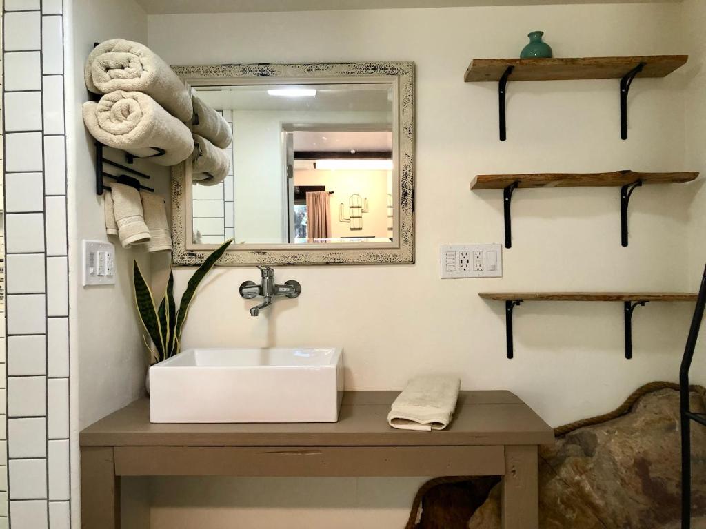 a bathroom with a sink and a mirror at NEW! Prickly Pear Unique Studio with bathroom built into the rocks in Prescott
