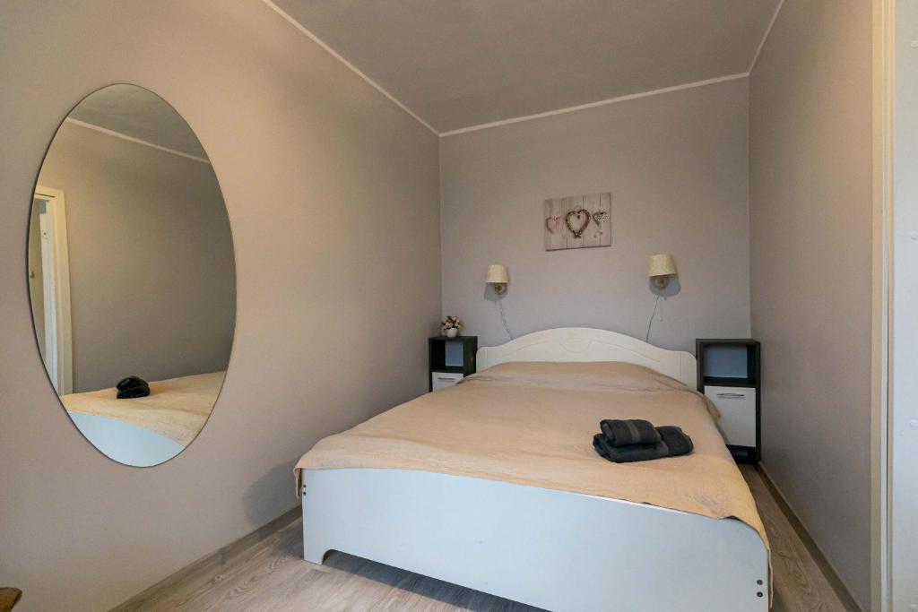 Schlafzimmer mit einem Bett und einem runden Spiegel in der Unterkunft Randla 14 Tallinn in Tallinn