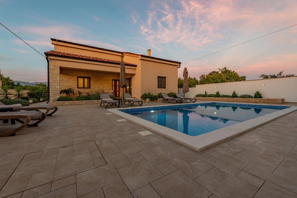Lovinac的住宿－Villa Roza，一个带游泳池和房子的后院
