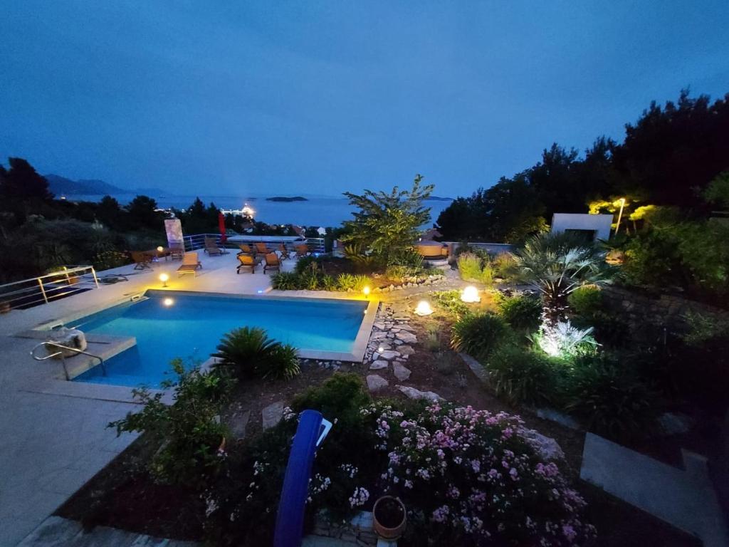 an overhead view of a swimming pool at night at Studio apartment in Orebic with sea view, terrace, air conditioning, WiFi 114-3 in Orebić