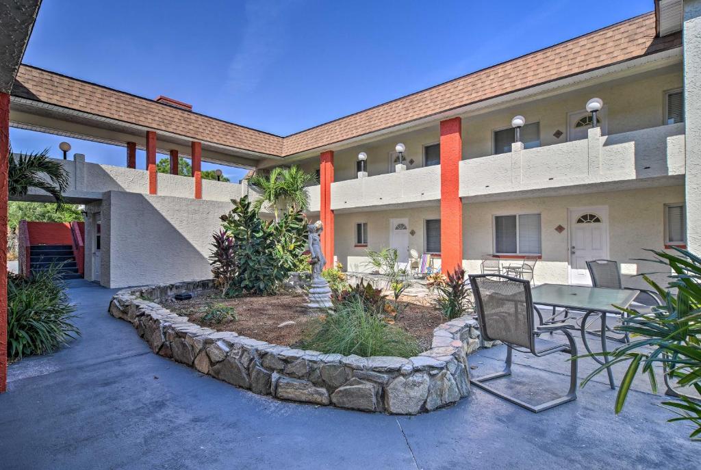 a courtyard of a building with a table and chairs at Sunny Indian Rocks Beach Condo Steps to Gulf! in Clearwater Beach
