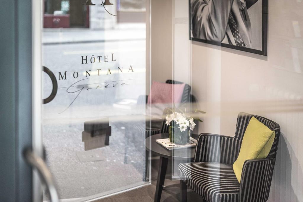 a table and two chairs in front of a window at Hotel Montana in Geneva