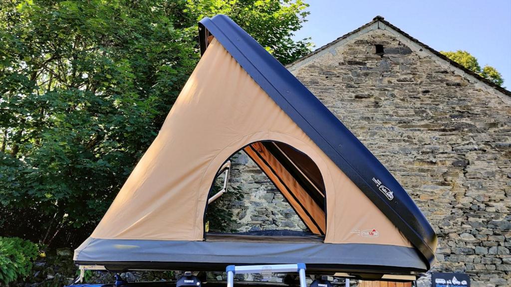a tent is set up in front of a stone building at Mallory Rooftop Tent Hire - from ElectricExplorers in Hawkshead