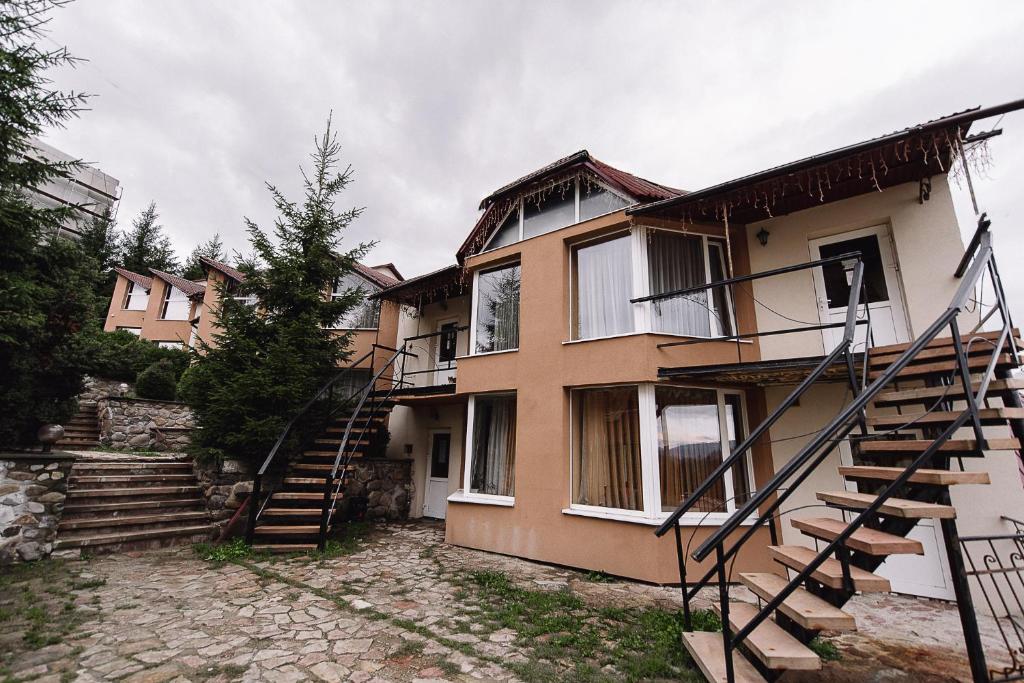 a house with a staircase in front of it at Toga cottage in Yablunytsya