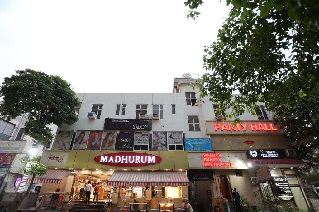 a building with signs on it on a city street at Mannat Residency in Ghaziabad