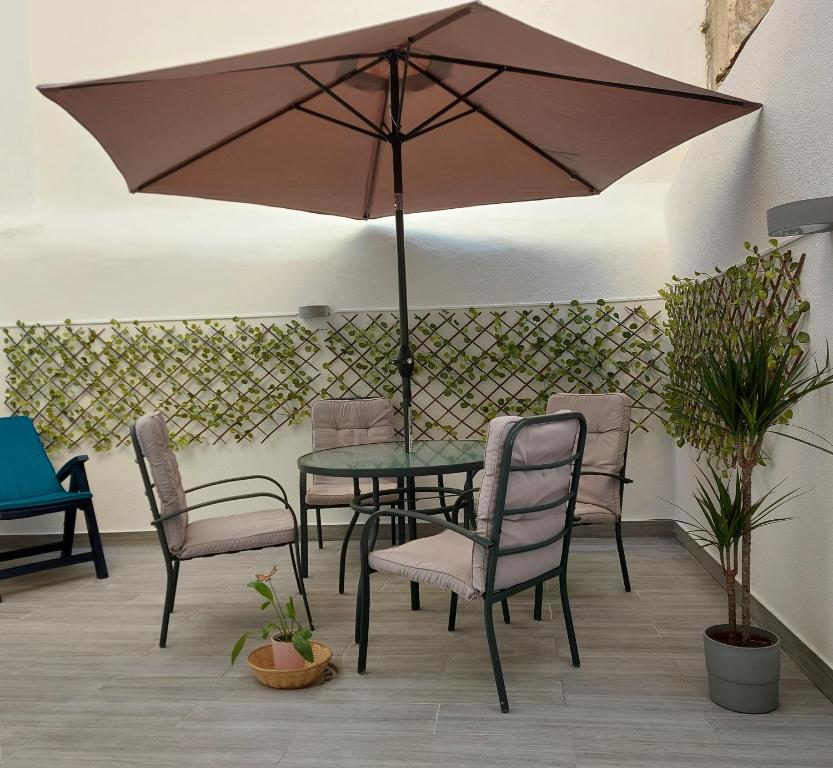 a table and chairs with an umbrella on a patio at Apartments in Central Lisbon in Lisbon