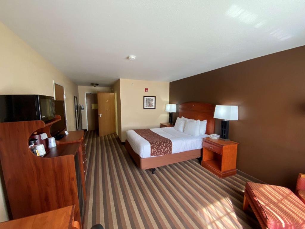 a hotel room with a bed and a couch at Best Western Manhattan Inn in Manhattan