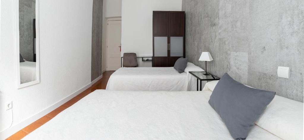 Postel nebo postele na pokoji v ubytování Hostal Tokio
