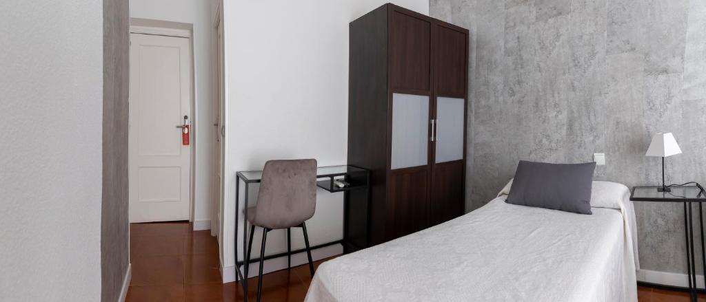 Postel nebo postele na pokoji v ubytování Hostal Tokio