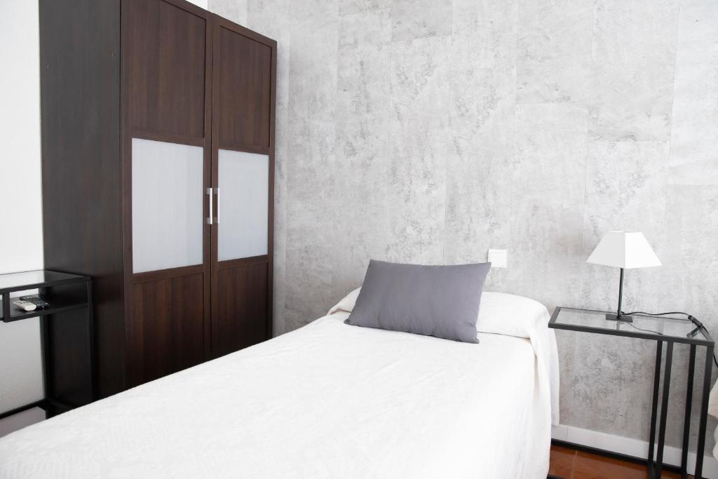 Postel nebo postele na pokoji v ubytování Hostal Tokio