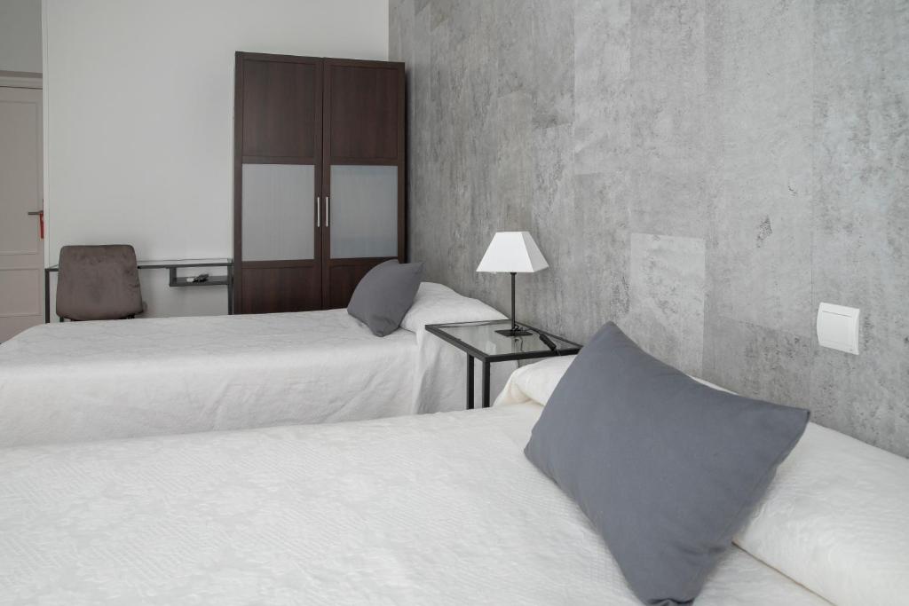 Postel nebo postele na pokoji v ubytování Hostal Tokio