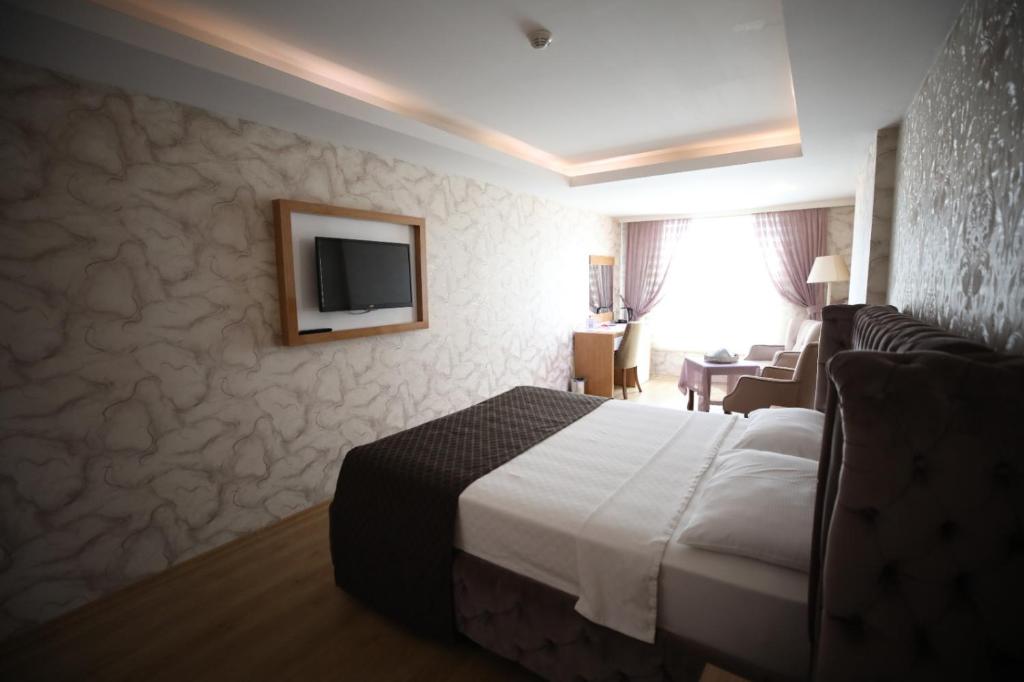 A bed or beds in a room at Bayazıt Hotel