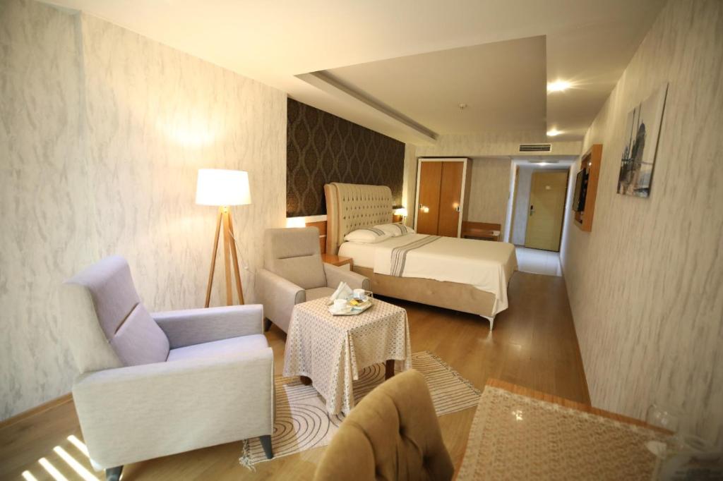 A bed or beds in a room at Bayazıt Hotel