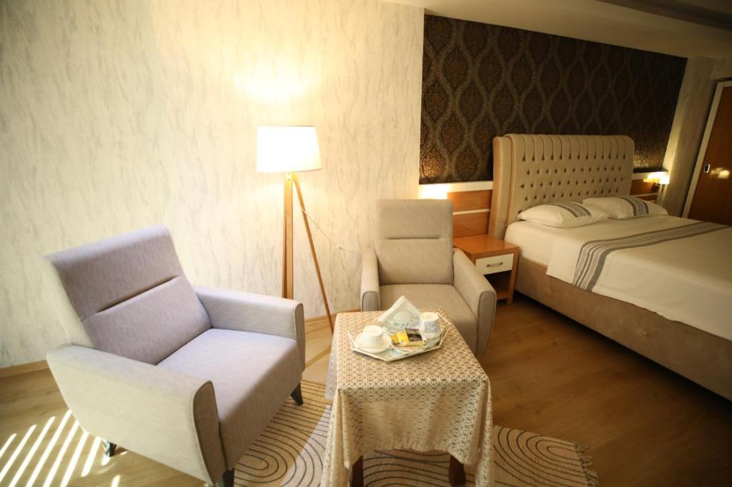 A bed or beds in a room at Bayazıt Hotel