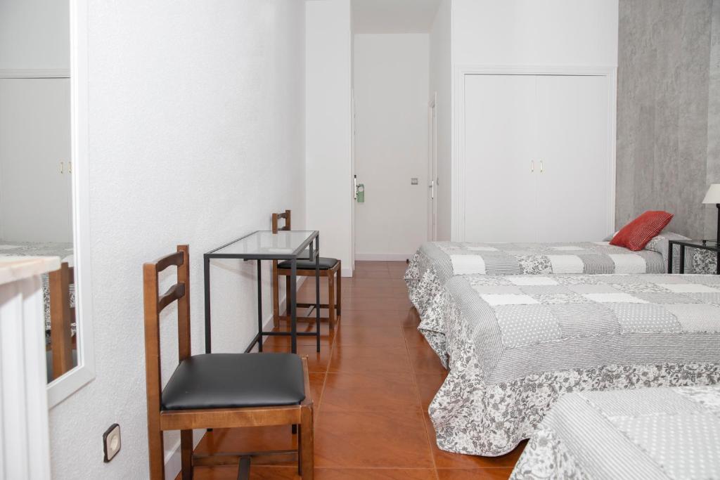 Postel nebo postele na pokoji v ubytování Hostal Tokio