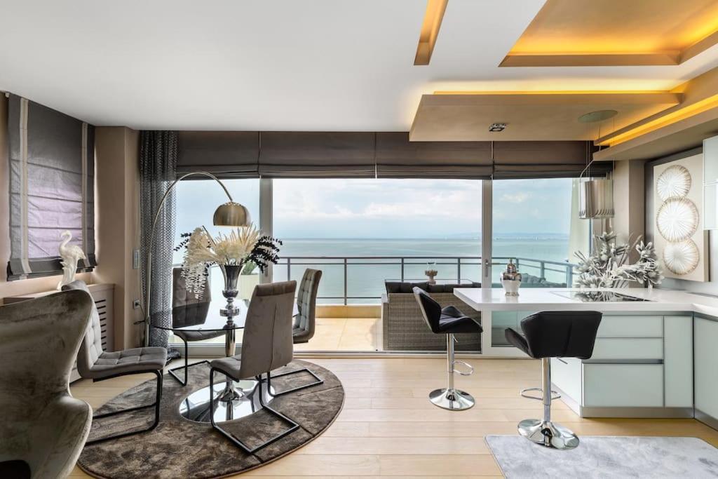 a kitchen and living room with a view of the ocean at Mega suite on the sea in Perea