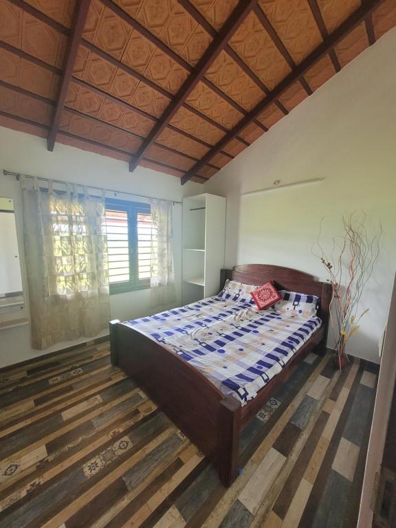 a bedroom with a bed in a room at Aashirvada in Chikmagalūr