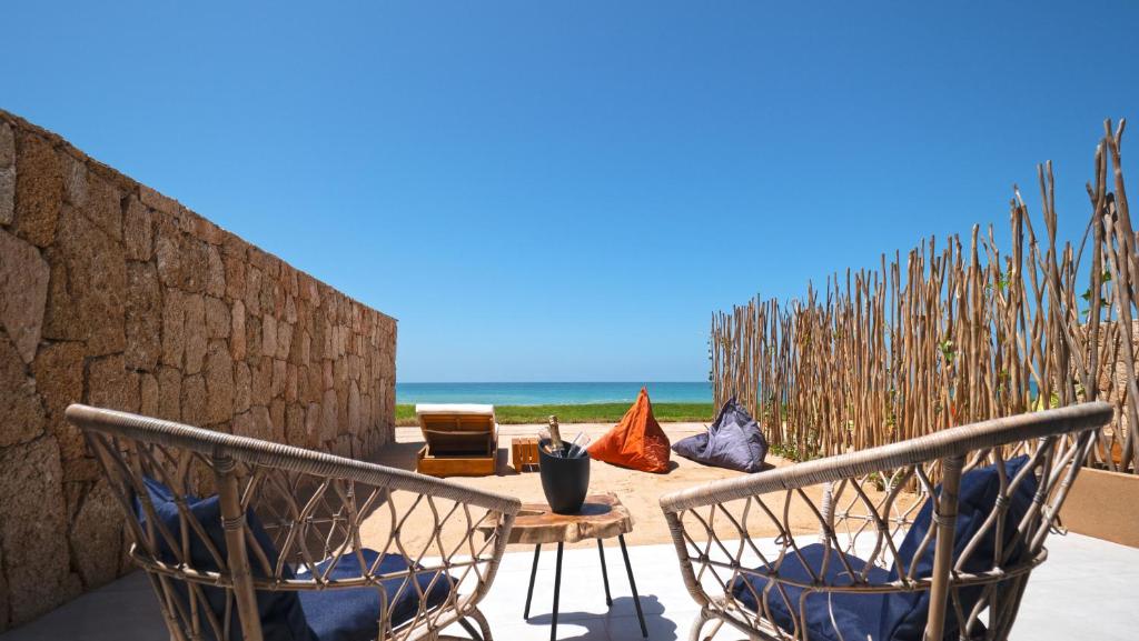 a patio with a table and chairs and the beach at Tulum Beach Resort Dakhla in Dakhla