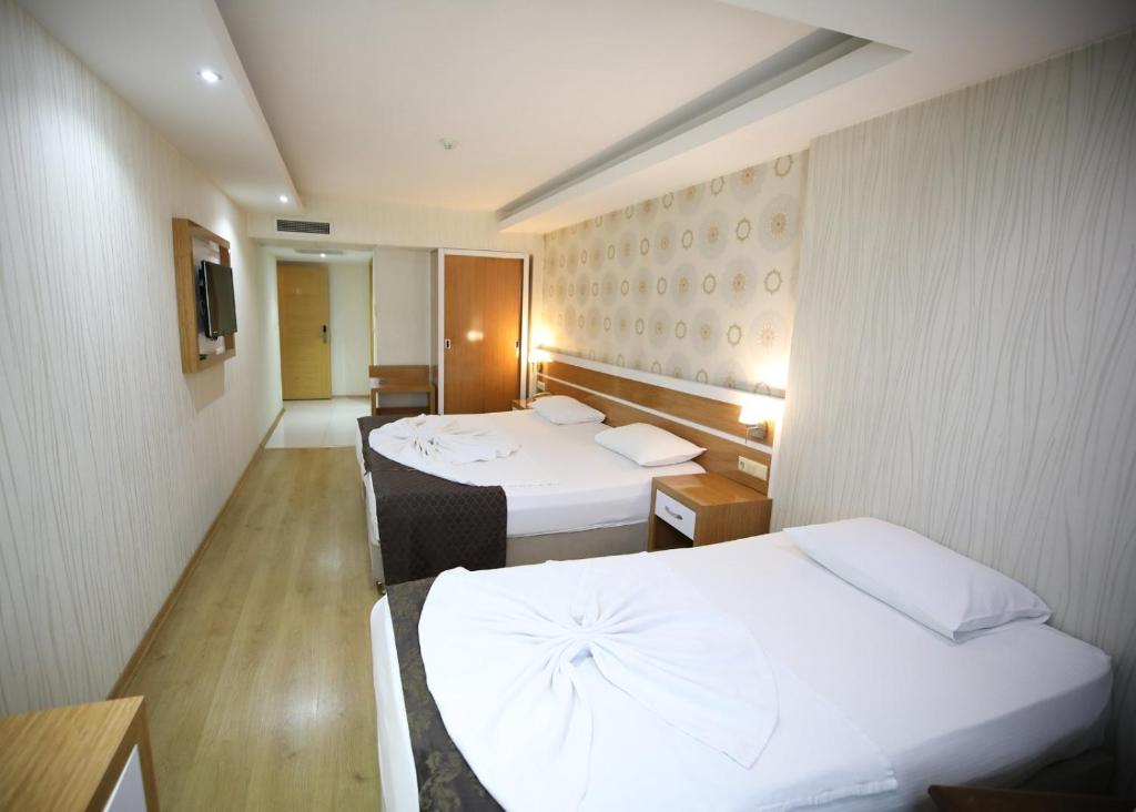 A bed or beds in a room at Bayazıt Hotel