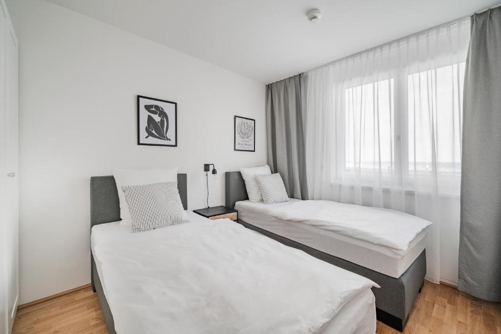 Łóżko lub łóżka w pokoju w obiekcie Arbio I Liv's Place Lux Apartments
