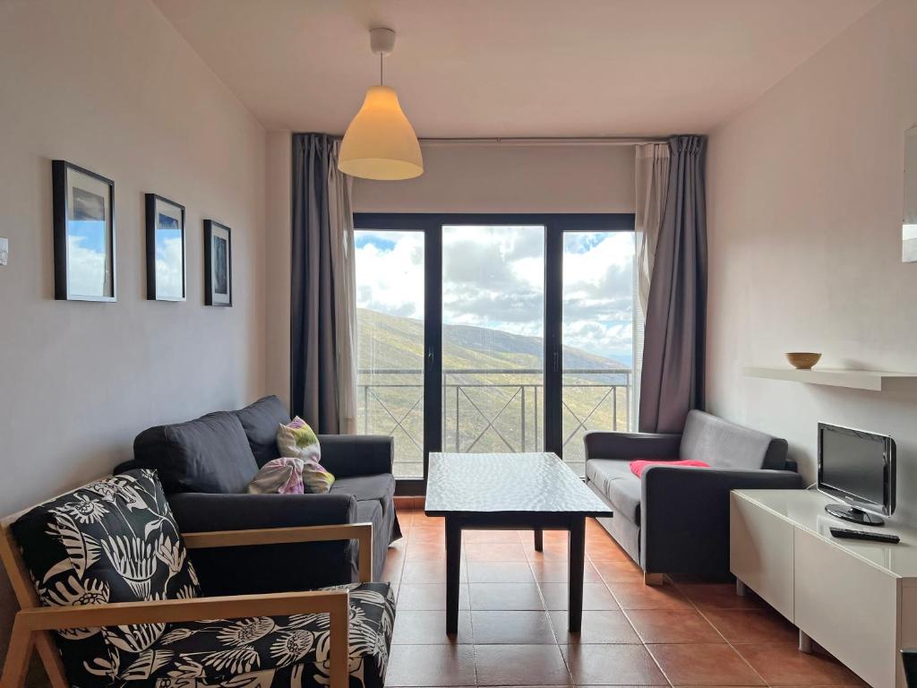 a living room with a couch and a table at Apartamentos Sierra Nevada 3000 in Sierra Nevada