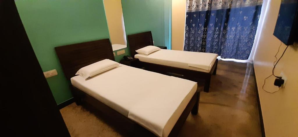 Postel nebo postele na pokoji v ubytování Chandru De Green