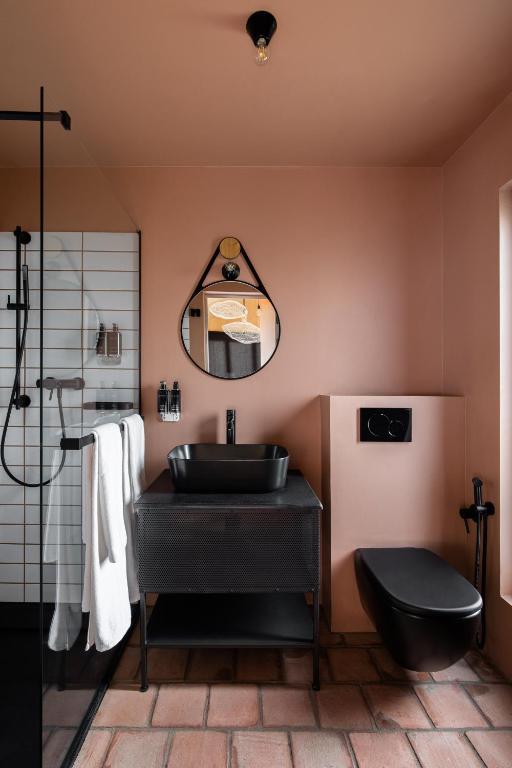 a bathroom with a black sink and a mirror at ARCA Resort 