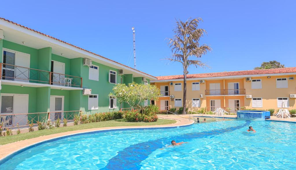 a pool at a hotel with people swimming in it at Boulevard Flats Mare Mansa in Porto Seguro