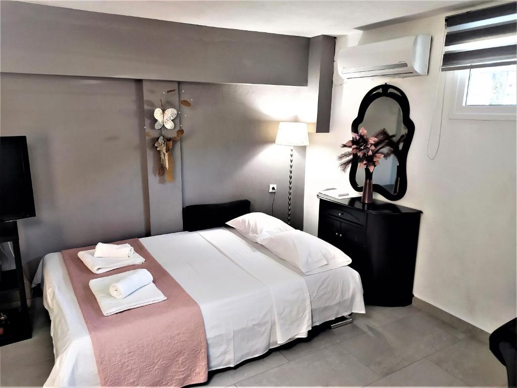 a hotel room with a bed and a mirror at MY HOME Trikala in Tríkala