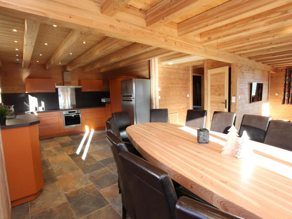 a kitchen and dining room with a wooden table and chairs at Chalet La Toussuire, 6 pièces, 14 personnes - FR-1-417-6 in La Toussuire