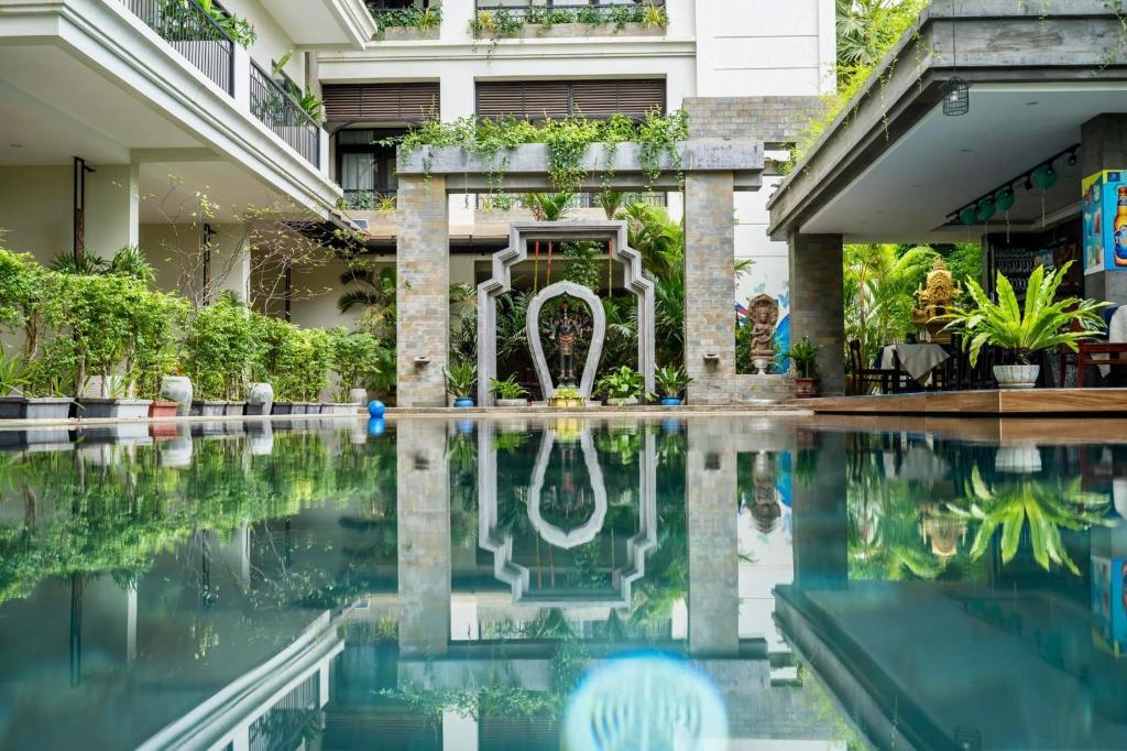 a swimming pool in front of a building at Bayon Modern Residence in Siem Reap