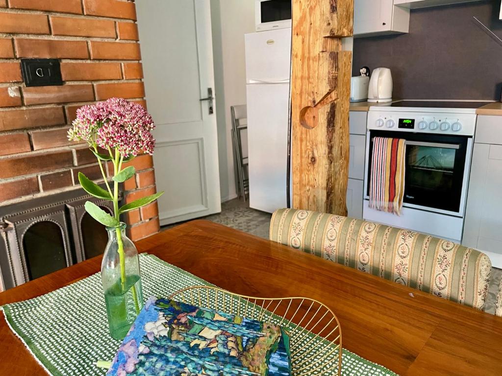 a table with a vase of flowers on top of it at Spacious Apartment in Old Town in Viljandi