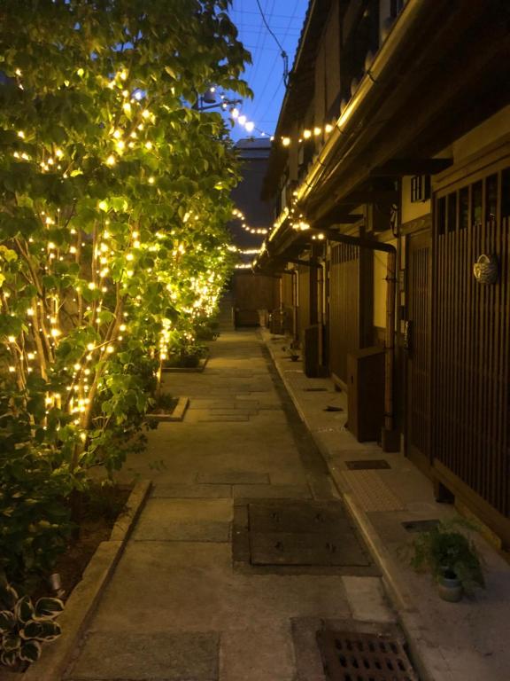 an alley with christmas lights on a building at Imakumano Terrace - Mokubei An 木米庵 in Kyoto