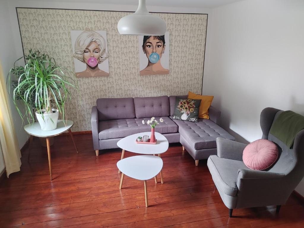 a living room with a purple couch and two tables at Himmel in Ebensee