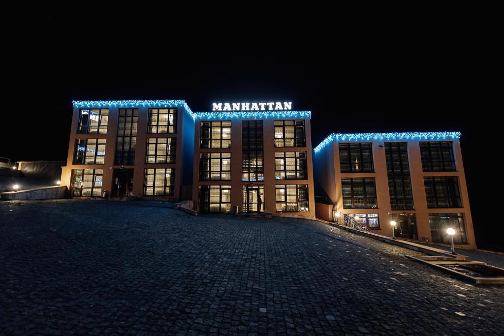 a large building with blue lights on it at night at Brooklyn 2 in Yablunytsya