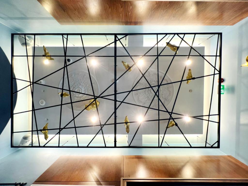 a room with a large window with birds on it at Hotel Solun in Trieste